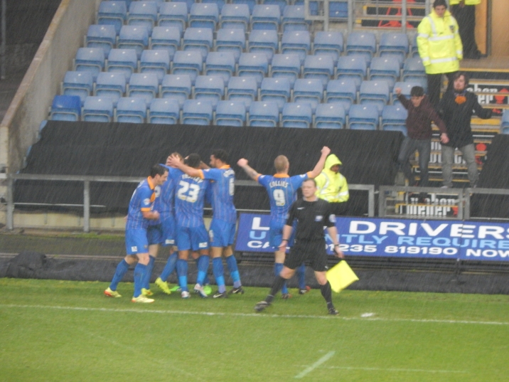 The Shrewsbury players celebrate at a rain/snow soaked Kassam